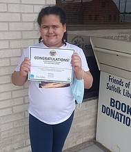 Teresa Sperry holding a certificate from winning the Suffolk Library's reading challenge over the summer.
Mandatory Credit:	Courtesy Nicole Sperry