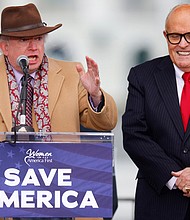 Attorney John Eastman gestures as he speaks next to then-US President Donald Trump's personal attorney Rudy Giuliani, as Trump supporters gather ahead of the president's speech to contest the certification by Congress of the results of the 2020 presidential election on the Ellipse in Washington, on January 6, 2021.
Mandatory Credit:	Jim Bourg/Reuters