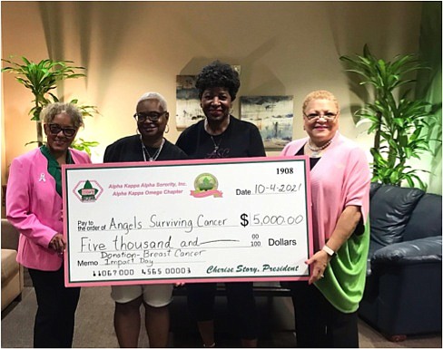 AKA Alpha Kappa Omega President Cherise Story and Vice President Laura Allen present $5,000 to Angels Surviving Cancer