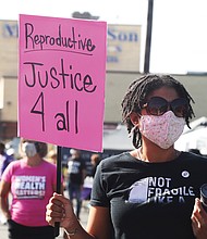 Marching to beat the bans-Hundreds of women and their advocates, including Kristin Rodriguez, 40, took to the streets last Saturday for the Bans Off Our Bodies RVA rally and march to show their support for a woman’s right to make her own decisions when it comes to abortion. The Richmond rally was one of scores held across the country last weekend in advance of the U.S. Supreme Court’s new session that began Monday in which a case challenging abortion rights will be heard. That case, out of Mississippi, is expected to be argued Dec. 1, and has the potential to overturn Roe v. Wade, the landmark 1973 case that guaranteed women the constitutional protection of being able to choose to have an abortion without excessive government restriction. Texas recently passed a law that also would ban abortion after six weeks, a timeframe when many women don’t know whether they are pregnant. In Richmond, speakers urged people to work to protect women’s reproductive freedom. The rally was held at Diversity Richmond, followed by a march down Sherwood Avenue to Hermitage Road. Ida Allen, who led chants with the bullhorn during the march, was a lead coordinator of the event.