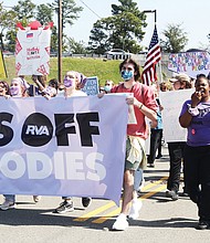 Marching to beat the bans-Hundreds of women and their advocates, including Kristin Rodriguez, 40, took to the streets last Saturday for the Bans Off Our Bodies RVA rally and march to show their support for a woman’s right to make her own decisions when it comes to abortion. The Richmond rally was one of scores held across the country last weekend in advance of the U.S. Supreme Court’s new session that began Monday in which a case challenging abortion rights will be heard. That case, out of Mississippi, is expected to be argued Dec. 1, and has the potential to overturn Roe v. Wade, the landmark 1973 case that guaranteed women the constitutional protection of being able to choose to have an abortion without excessive government restriction. Texas recently passed a law that also would ban abortion after six weeks, a timeframe when many women don’t know whether they are pregnant. In Richmond, speakers urged people to work to protect women’s reproductive freedom. The rally was held at Diversity Richmond, followed by a march down Sherwood Avenue to Hermitage Road. Ida Allen, who led chants with the bullhorn during the march, was a lead coordinator of the event.