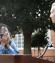 Ashley S. Bland reacts with utter surprise Monday as Gov. Ralph S. Northam announces that she is Virginia’s Region 1 Teacher of the Year 2021 during a program at Richmond’s John B. Cary Elementary School, where Ms. Bland thought she would be leading a tour of the school’s outdoor environmental learning center.