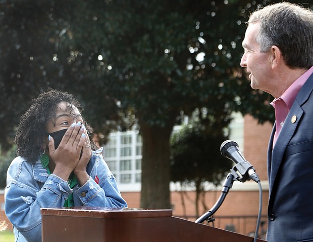 Ashley S. Bland reacts with utter surprise Monday as Gov. Ralph S. Northam announces that she is Virginia’s Region 1 Teacher of the Year 2021 during a program at Richmond’s John B. Cary Elementary School, where Ms. Bland thought she would be leading a tour of the school’s outdoor environmental learning center.