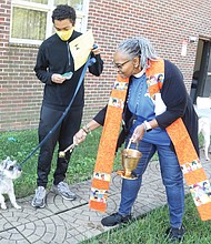 Blessing of the Animals-The Rev. Marlene E. Forest blesses Chico, a miniature schnauzer, during a Blessing of the Animals ceremony last Saturday at St. Philip’s Episcopal Church on Hanes Avenue in North Side. Several families brought their dogs to the outdoor ceremony. With Chico is Jordan Williams, while Jay Greene brought his 13-year-old yellow Labrador retriever, Oscar. In addition to the blessing, each pet received a gift. People also brought offerings of pet food and cat litter to be donated to Richmond Animal Care & Control.