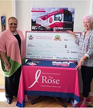 AKA Alpha Kappa Omega President Cherise Story and Vice President Laura Allen present $5,000 to Chris Noble of The Rose