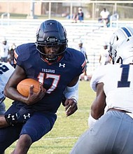 Virginia State University quarterback D’Vonte Waller runs with the ball to gain yardage last Saturday in the Trojans’ 33-9 win over St. Augustine’s University at Rogers Stadium in Ettrick.