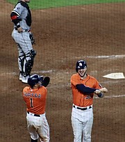 Tucker celebrates with teammate Carlos Correa in Game 2 of the ALDS