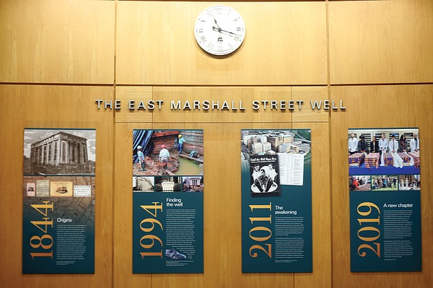 This display of four panels tells the story of African-Americans whose bodies were stolen from graves, used as teaching tools for Richmond medical students before the Civil War and then discarded in a nearby well. Location of panels: Outside the auditorium of the Hermes A. Kontos Medical Sciences Building, 1217 E. Marshall St., on the medical campus of Virginia Commonwealth University. The bones of the unidentified people were found in a long-capped well in 1994 during the construction of the building. The university and two community committees set up by VCU have considered how to properly honor the remains that are now in custody of the state Department of Historic Resources. Dr. Peter Buckley, dean of the VCU School of Medicine, called the display the latest effort by the school to recognize the humanity of those involved and “to honor and demonstrate our respect for the lives of these ancestors.” The panels, from left to right, present a timeline of events involving the remains from 1844 to 2019.