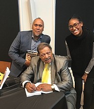 Former Richmond City Councilman Henry W. “Chuck” Richardson signs copies of his new memoir, “Cease Fire! Cease Fire!”, last Saturday for John H. Mitchell, the great-great-nephew of the late Richmond Planet newspaper editor John Mitchell Jr., and Liza Mickens, the great-great-granddaughter of the late noted businesswoman Maggie L. Walker. Location: Black History Museum & Cultural Center of Virginia in Jackson Ward.