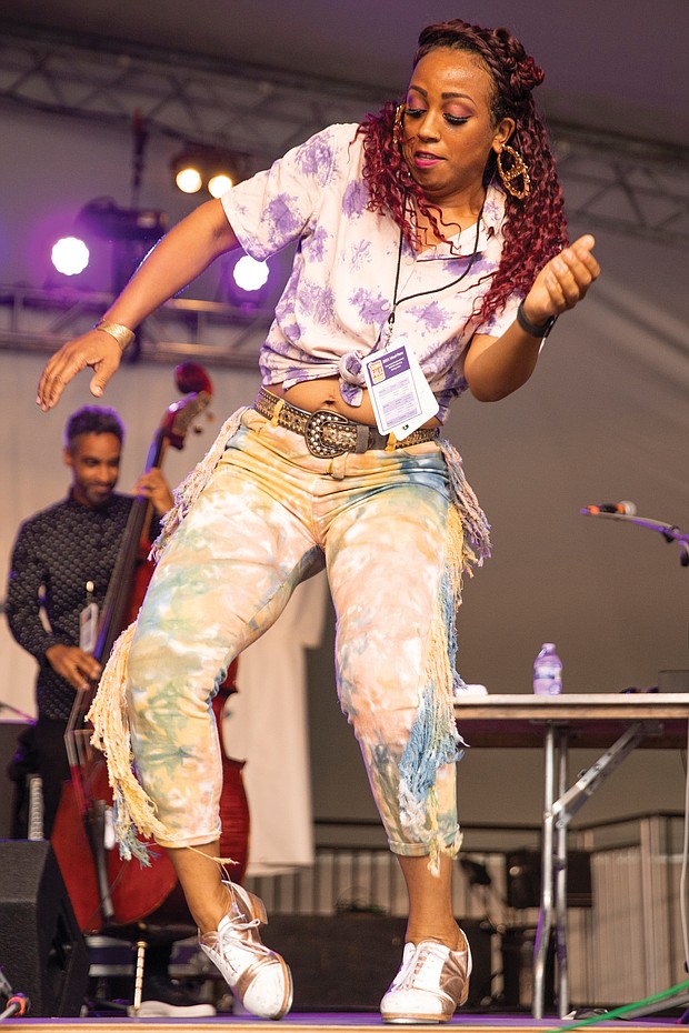 Tap dancer and chanteuse Brinae Ali dances to the music of Baltimore jazz group Dizzy Spellz Saturday afternoon on the Altria Stage.