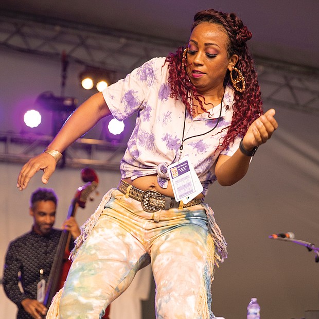 Tap dancer and chanteuse Brinae Ali dances to the music of Baltimore jazz group Dizzy Spellz Saturday afternoon on the Altria Stage.