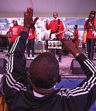 Thomas Woodson grooves as he records Rare Essence, a go-go band from Washington that has been popular since the mid-1970s, during a performance on the Dominion Stage Saturday evening.