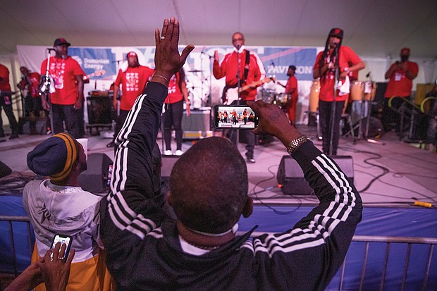 Thomas Woodson grooves as he records Rare Essence, a go-go band from Washington that has been popular since the mid-1970s, during a performance on the Dominion Stage Saturday evening.