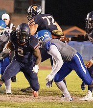 Virginia State University running back Kimo Clarke takes on Elizabeth City State University defensive players during last Saturday’s 35-7 victory over the Vikings.