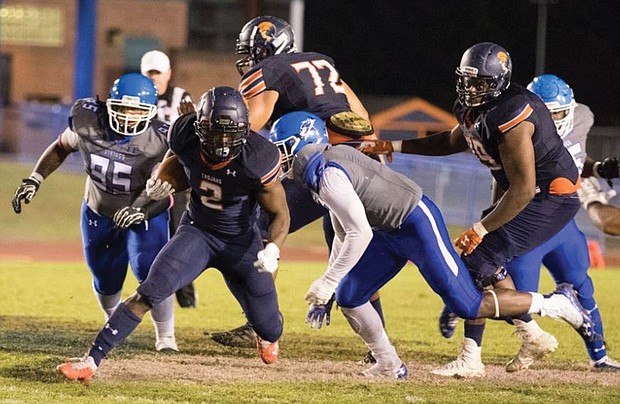 Virginia State University running back Kimo Clarke takes on Elizabeth City State University defensive players during last Saturday’s 35-7 victory over the Vikings.