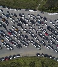 America's factories have struggled with shortages of materials and qualified workers. New Ford F-Series pickup trucks are shown here stored in a lot during a semiconductor shortage at Kentucky Speedway in Sparta, Kentucky, U.S., on Friday, July 16, 2021.
Mandatory Credit:	Jeffrey Scott Dean/Bloomberg/Getty Images
