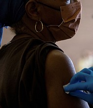 A nurse sanitizes a patient's arm before administering a Covid-19 vaccine booster during a Pfizer-BioNTech vaccination clinic in Southfield, Michigan, on September 29.
Mandatory Credit:	Emily Elconin/Reuters