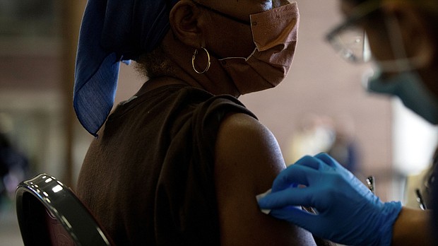 A nurse sanitizes a patient's arm before administering a Covid-19 vaccine booster during a Pfizer-BioNTech vaccination clinic in Southfield, Michigan, on September 29.
Mandatory Credit:	Emily Elconin/Reuters