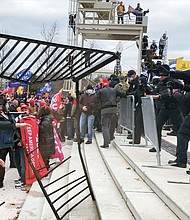 Rioters approach police on January 6, in the HBO documentary 'Four Hours at the Capitol.'
Mandatory Credit:	Courtesy HBO