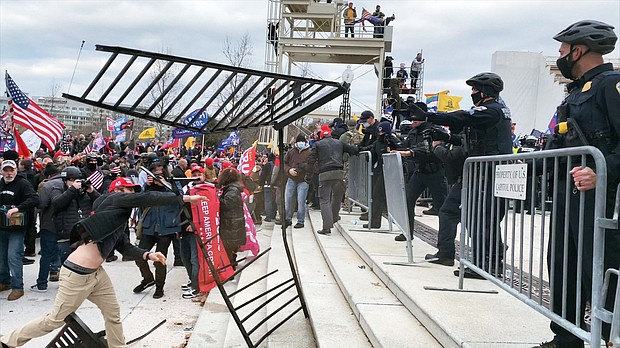 Rioters approach police on January 6, in the HBO documentary 'Four Hours at the Capitol.'
Mandatory Credit:	Courtesy HBO