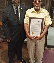 Ronald White, right, holds the resolution he received recently from the Henrico County Board of Supervisors acknowledging his pioneering role as the first Black player on the Highland Springs High School football team. With him is the Rev. Joe Ellison, the team’s chaplain.