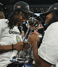 The Chicago Sky’s Diamond DeShields, left, and Lexie Brown celebrate with the championship trophy Sunday after defeating the Phoenix Mercury 80-74 in Game 4 of the WNBA Finals in Chicago.