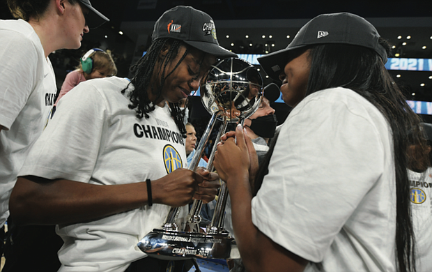 The Chicago Sky’s Diamond DeShields, left, and Lexie Brown celebrate with the championship trophy Sunday after defeating the Phoenix Mercury 80-74 in Game 4 of the WNBA Finals in Chicago.