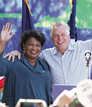 Voting rights advocate Stacey Abrams of Georgia campaigns with Democratic gubernatorial candidate Terry McAuliffe at a rally in Norfolk last Sunday. She is returning to the campaign trail on Sunday, Oct. 24, to stump in Charlottesville for Mr. McAuliffe with musician Dave Matthews and Jaime Harrison, chairman of the Democratic National Committee.