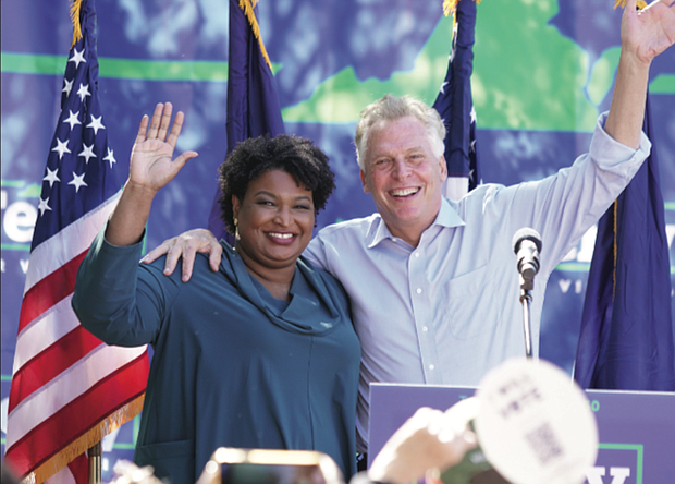 Voting rights advocate Stacey Abrams of Georgia campaigns with Democratic gubernatorial candidate Terry McAuliffe at a rally in Norfolk last Sunday. She is returning to the campaign trail on Sunday, Oct. 24, to stump in Charlottesville for Mr. McAuliffe with musician Dave Matthews and Jaime Harrison, chairman of the Democratic National Committee.