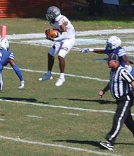 Virginia Union University wide receiver Larry Hackey goes high for a reception during last Saturday’s game against Chowan University in Murfreesboro, N.C.