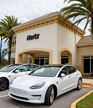 Tesla Model 3 electric vehicles at a Hertz location.
Mandatory Credit:	Hertz