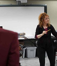 Jeannette Sorrell, founding artistic director of the baroque orchestra Apollo’s Fire, works with the Southland College Prep choir on a piece for the October 26th concert launching the Matteson School District 162 Strings Program. Photo by Eric Lites