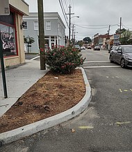 The city installed 14 concrete planters a year ago along Brookland Park Boulevard, such as this one at its intersection with Garland Avenue, to slow down traffic and beautify the block. Six were removed after complaints and a petition by residents and business owners.