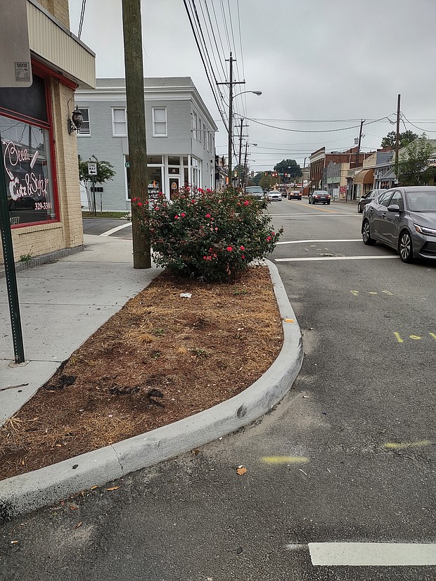 The city installed 14 concrete planters a year ago along Brookland Park Boulevard, such as this one at its intersection with Garland Avenue, to slow down traffic and beautify the block. Six were removed after complaints and a petition by residents and business owners.