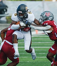 Virginia Union University #2 Bryan Epps, left, and #15 Marquis Hamilton, right, close in on Bowie State University #19 Kwincy Hall.