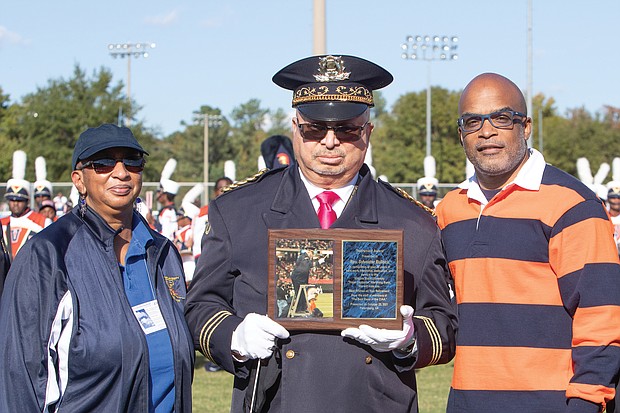 VSU President Makola Abdullah presents a plaque to the Rev. Sylvester Bullock, VSU’s assistant band director, who is retiring after 35 years of service to the Trojan Explosion March Band.