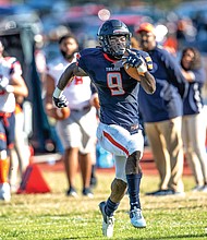 Virginia State University’s Darius Hagans takes the ball in for a touchdown late in the second quarter of the homecoming game against Lincoln University.