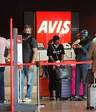 People wait in line at Avis rental agency in the Miami International Airport Car Rental Center on April 12, 2021 in Miami, Florida. Customers are finding that car rental agencies have limited or no supply of vehicles as people begin traveling again after being locked down during the pandemic.
Mandatory Credit:	Joe Raedle/Getty Images
