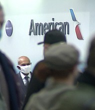 People wait in line at an American Airlines counter at an airport in Charlotte, N.C. on Sunday, Oct. 31, 2021. The airline has canceled another 250 flights on Monday.
Mandatory Credit:	WSOC-TV/AP
