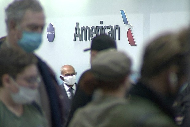 People wait in line at an American Airlines counter at an airport in Charlotte, N.C. on Sunday, Oct. 31, 2021. The airline has canceled another 250 flights on Monday.
Mandatory Credit:	WSOC-TV/AP