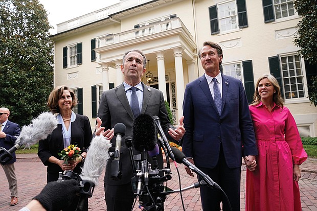 Gov. Ralph S. Northam, second from left, speaks to the media as Gov.-elect Glenn A. Youngkin and his wife, Suzanne, right, and First Lady Pam Northam listen after a luncheon Nov. 4 at the Governor’s Mansion in Capitol Square in Downtown.