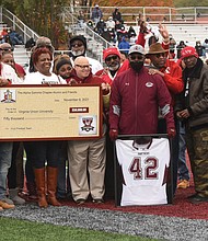 It was William “Dil” Dillon Day at Virginia Union University last Saturday during the Panthers’ annual gridiron clash with the Trojans of Virginia State University.
During halftime of the game at VUU’s Hovey Stadium, family members, former teammates and fellow members of Kappa Alpha Psi Fraternity participate in a ceremony to officially retire the No. 42 jersey that the late Mr. Dillon wore as a VUU player from 1979 to 1982.
The fraternity’s Alpha Gamma Chapter also donated $50,000 to the VUU football team during the ceremony.
Mr. Dillon, a Detroit native who later won plaudits as a local softball player and high school basketball official before his death in 2017 at age 59, was recognized and remembered for his remarkable playing career.
As recounted during the ceremony, Mr. Dillon was a star defender for the Panthers under Coach Willard Bailey. During his VUU career, he picked off 30 opponents’ passes, including 16 during his sophomore season. He was selected three years in a row as an Associated Press Little All-American while helping VUU earn four straight invitations to the NCAA Division II football tournament.