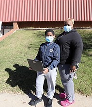 Jayden Holmes, 9, a student at Carver elementary School, is ready to get his COVID-19 vaccine. On Monday, he and his mother, Shankita Holmes, who works in nursing, were outside the Arthur Ashe Jr. Athletic Center on Arthur Ashe boulevard, which has been set up as a community vaccination center by local health officials. The youngster, who was nervous about getting a needle, survived the shot and said he was feeling good when he left. Children ages 5 to 11 are now eligible to receive the vaccine.