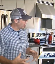 Eric Peterson stands in the kitchen of his North Andover, Massachussets home. Peterson says he doesn't pay a utility bill because his house is powered by electrivity.
Mandatory Credit:	WCVB