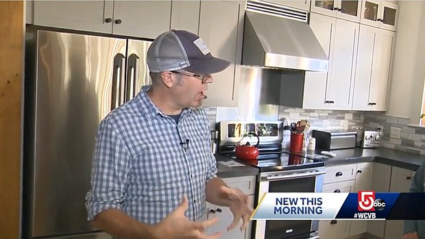 Eric Peterson stands in the kitchen of his North Andover, Massachussets home. Peterson says he doesn't pay a utility bill because his house is powered by electrivity.
Mandatory Credit:	WCVB