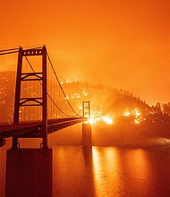 Around $50 billion of President Joe Biden's infrastructure package is marked for climate resilience. The Bidwell Bar Bridge in Oroville, California, surrounded by fire in September 2020.
Mandatory Credit:	JOSH EDELSON/AFP via Getty Images
