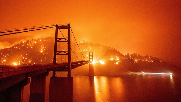 Around $50 billion of President Joe Biden's infrastructure package is marked for climate resilience. The Bidwell Bar Bridge in Oroville, California, surrounded by fire in September 2020.
Mandatory Credit:	JOSH EDELSON/AFP via Getty Images