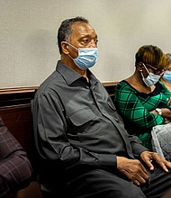 The Rev. Jesse Jackson, center, sits with Ahmaud Arbery's mother, Wanda Cooper-Jones, center right, during the trial of Greg McMichael and his son, Travis McMichael, and a neighbor, William "Roddie" Bryan in the Glynn County Courthouse, Monday, Nov. 15, 2021, in Brunswick, Ga. The three are charged with the February 2020 slaying of 25-year-old Ahmaud Arbery.
Mandatory Credit:	Stephen B. Morton/Pool/AP