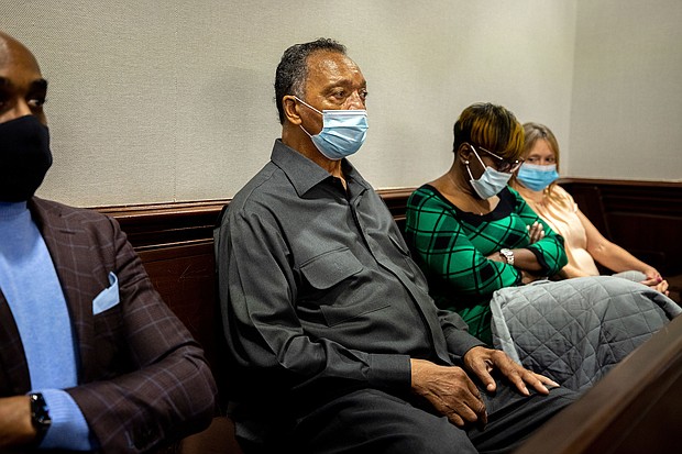 The Rev. Jesse Jackson, center, sits with Ahmaud Arbery's mother, Wanda Cooper-Jones, center right, during the trial of Greg McMichael and his son, Travis McMichael, and a neighbor, William "Roddie" Bryan in the Glynn County Courthouse, Monday, Nov. 15, 2021, in Brunswick, Ga. The three are charged with the February 2020 slaying of 25-year-old Ahmaud Arbery.
Mandatory Credit:	Stephen B. Morton/Pool/AP