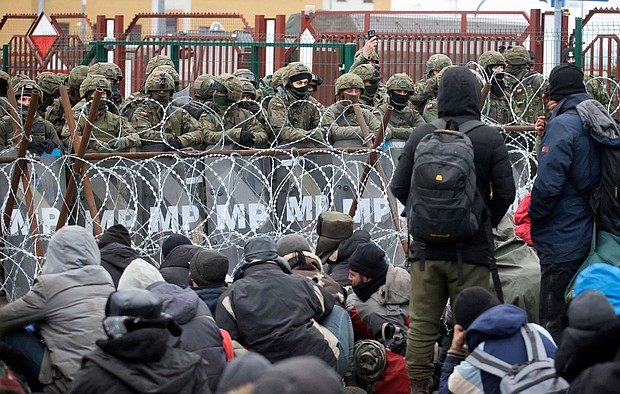 Migrants from the Middle East and elsewhere gather at the checkpoint "Kuznitsa" at the Belarus-Poland border near Grodno, Belarus, on Monday, Nov. 15, 2021.
Mandatory Credit:	Leonid Shcheglov/Belta/AP